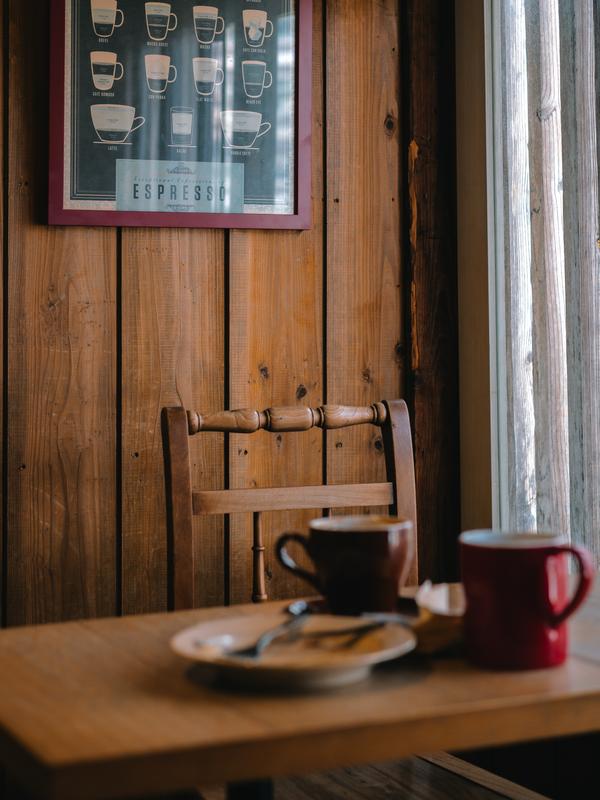 A wooden chair and coffee in an old diner